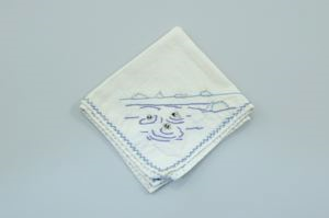 Image of Three seal heads poking out of water, one of a set of 4 embroidered napkins, each with different outdoor activity 